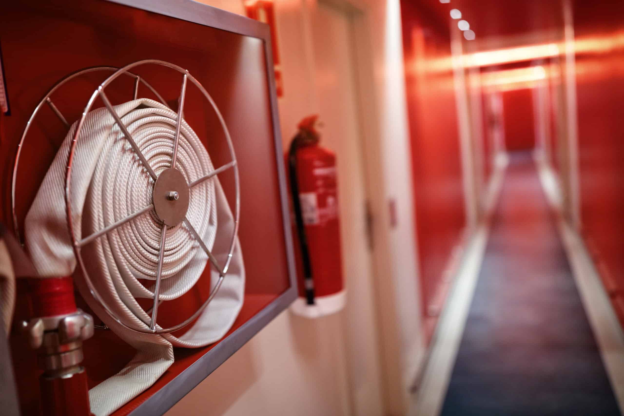 fire-extinguisher-and-hose-reel-in-hotel-corridor-2024-09-17-01-48-03-utc-1-scaled.jpg